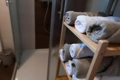 a bunch of towels on a shelf in a bathroom at Lazy Haven in Moravske Toplice