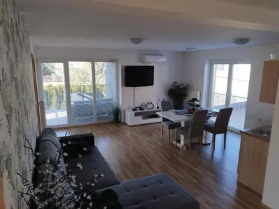 a living room with a couch and a table at Lazy Haven in Moravske Toplice