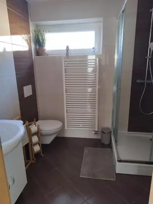 a bathroom with a toilet and a sink and a shower at Lazy Haven in Moravske Toplice