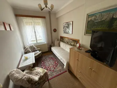 a living room with a couch and a flat screen tv at Apartma Prisojnik in Kranjska Gora