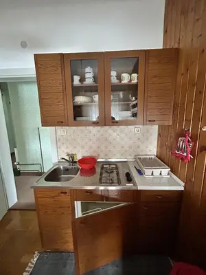 a kitchen with a sink and a stove top oven at Apartma Prisojnik in Kranjska Gora