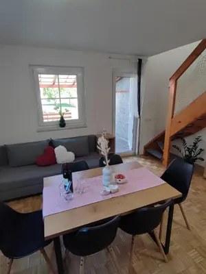 a living room with a table and a couch at Apartment by MICHELLE - Terme Čatež House in Čatež ob Savi