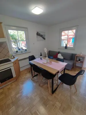 a living room with a table and chairs and a couch at Apartment by MICHELLE - Terme Čatež House in Čatež ob Savi