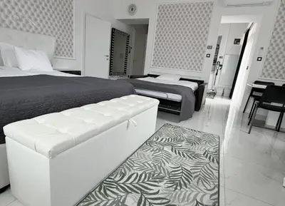 a bedroom with a bed and a couch and a table at SLOAPART Apartments in Rogaška Slatina