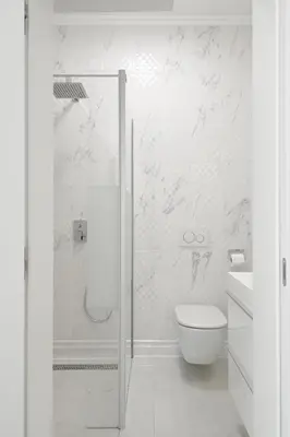 a white bathroom with a shower and a toilet at SLOAPART Apartments in Rogaška Slatina