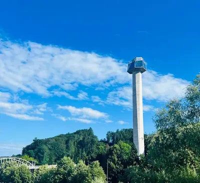 a tower in the middle of a park with trees at SLOAPART Apartments in Rogaška Slatina