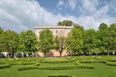 a large building with a garden in front of it at SLOAPART Apartments in Rogaška Slatina