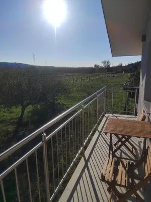 a balcony with a table and a view of a field at Studio Apartma KIMI in Nova Gorica
