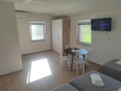 a living room with a table and a couch at Studio Apartma KIMI in Nova Gorica