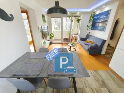 a dining table with a p sign on it in a living room at Family Nest near Ljubljana with free parking in Dobrova
