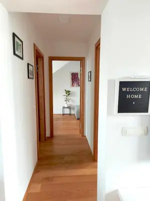 a hallway leading to a home with a welcome home sign at Family Nest near Ljubljana with free parking in Dobrova