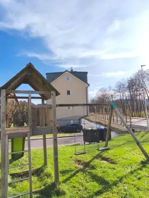 a playground in a yard with a swing at Family Nest near Ljubljana with free parking in Dobrova