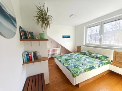 a bedroom with a bed and a window at Family Nest near Ljubljana with free parking in Dobrova