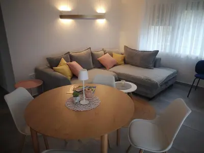 a living room with a table and a couch at Apartma Mia Nadiža in Kobarid