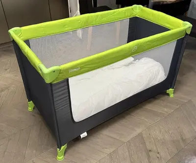 a small green and black bunk bed with wheels at Downtown appartment with a view in Ljubljana