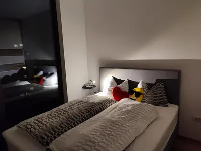 a bedroom with a bed with a large mirror at Downtown appartment with a view in Ljubljana