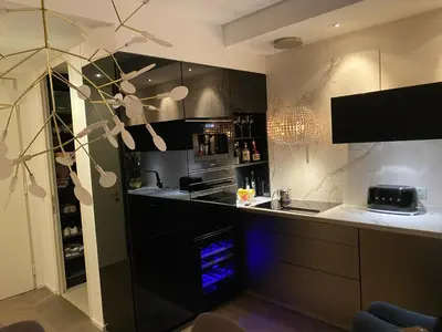 a kitchen with black and white cabinets and a stove at Downtown appartment with a view in Ljubljana
