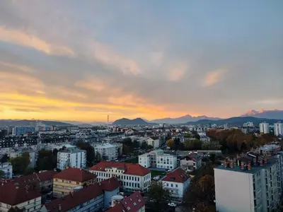 a view of a city at sunset with buildings at Downtown appartment with a view in Ljubljana
