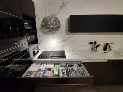 a kitchen with a drawer filled with magazines at Downtown appartment with a view in Ljubljana