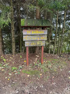 a street sign in the middle of a forest at Apartments Barbra - Robinson life in Slovenj Gradec