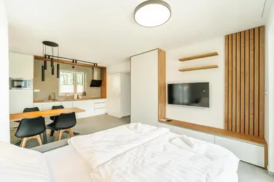 a bedroom with a bed and a dining table at Family apartments Soča Splash Home in Bovec