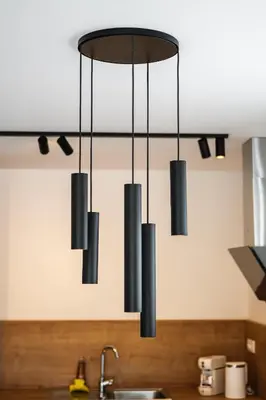 a cluster of black lights hanging from a kitchen ceiling at Family apartments Soča Splash Home in Bovec