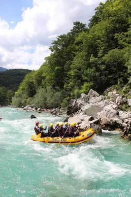 a group of people in a raft in a river at Family apartments Soča Splash Home in Bovec