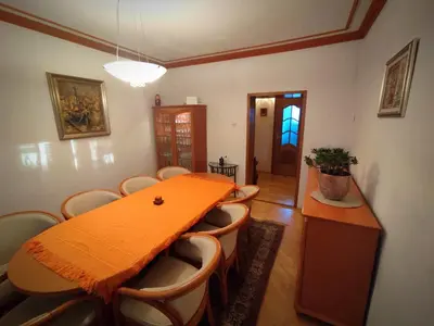 a dining room with a table and chairs at House IZI - parking, garden, 8 min ride to center in Maribor