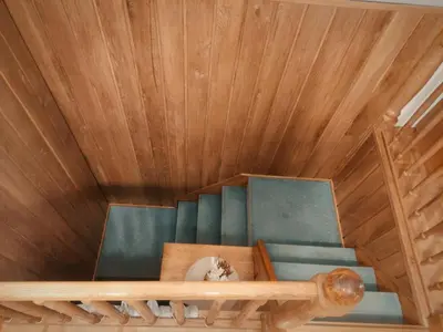 a room with a wooden ceiling and a couch at House IZI - parking, garden, 8 min ride to center in Maribor