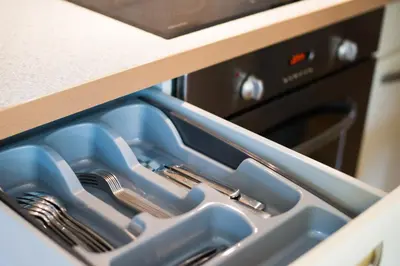 an open kitchen drawer with utensils in it at Apartment Ani in Bled