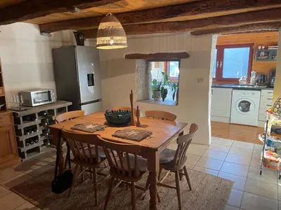 a kitchen with a wooden table and chairs in a room at Nadiza Hilltop Retreat in Breginj