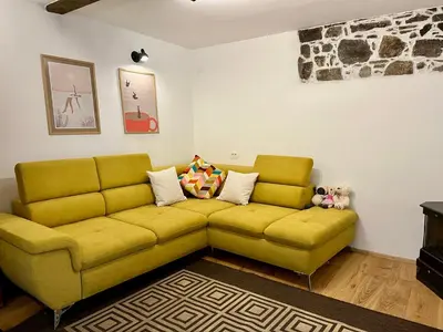 a yellow couch sitting in a living room at Apartment Rozalka Vipava valley in Podnanos