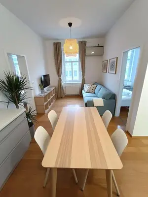 a living room with a table and a couch at Two-bedroom city apartment in Ljubljana