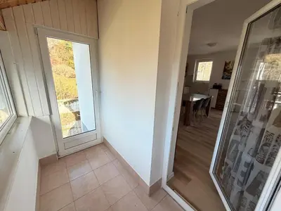 a hallway with a door and a dining room at Apartments Rupnik in Bovec