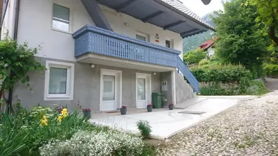 a house with a blue balcony on top of it at Apartments Rupnik in Bovec