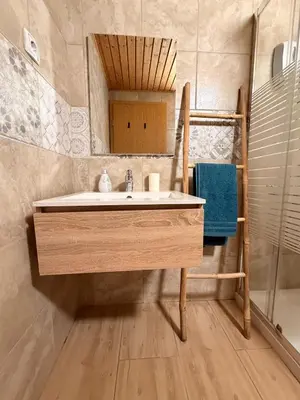 a bathroom with a sink and a mirror at Apartments Rupnik in Bovec