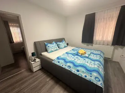 a bedroom with a bed with a teddy bear on it at Apartments Harmony Joe in Radenci