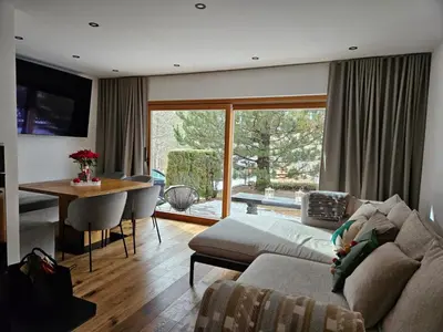 a living room with a couch and a table at Chalet Gozd Martuljek in Gozd Martuljek