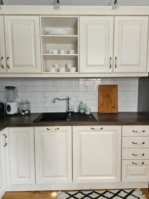 a kitchen with white cabinets and a sink at Chalet Gozd Martuljek in Gozd Martuljek