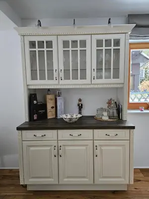 a kitchen with white cabinets and a black counter top at Chalet Gozd Martuljek in Gozd Martuljek