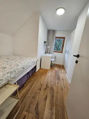 a bedroom with a bed and a desk in it at Chalet Gozd Martuljek in Gozd Martuljek