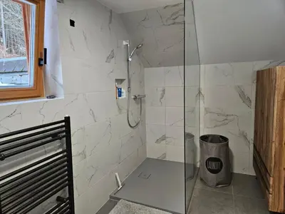 a bathroom with a shower with a glass door at Chalet Gozd Martuljek in Gozd Martuljek