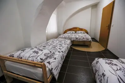 two beds in a small room with an attic at Hostel - Rooms Kaj & Kaja in Slivnica pri Mariboru