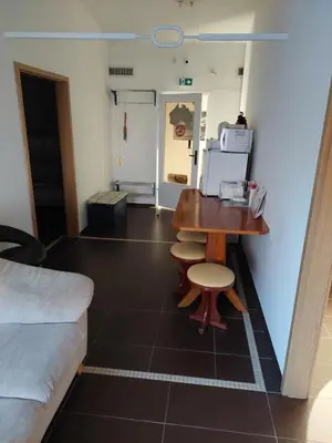 a room with a desk and a table and a couch at Hostel - Rooms Kaj & Kaja in Slivnica pri Mariboru