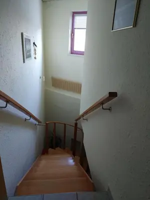 a staircase in a room with wooden steps and a window at Hostel - Rooms Kaj & Kaja in Slivnica pri Mariboru