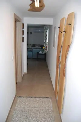 a hallway with two wooden surfboards on the wall at Slosarjeva Holiday House - Alpine View & Modern Comfort in Preddvor