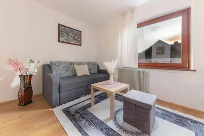 a living room with a couch and a table at Apt Regina with balcony and parking in Bled