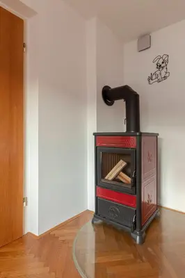 a stove in the corner of a room at Apt Regina with balcony and parking in Bled