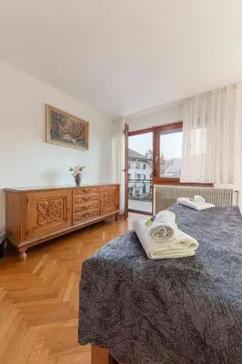 a bedroom with two beds and a large window at Apt Regina with balcony and parking in Bled
