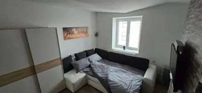 a living room with a couch and a window at Apartma Minka in Miklavž pri Ormožu